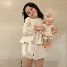 Load image into Gallery viewer, Child holding a doll wearing a matching outfit against a plain background